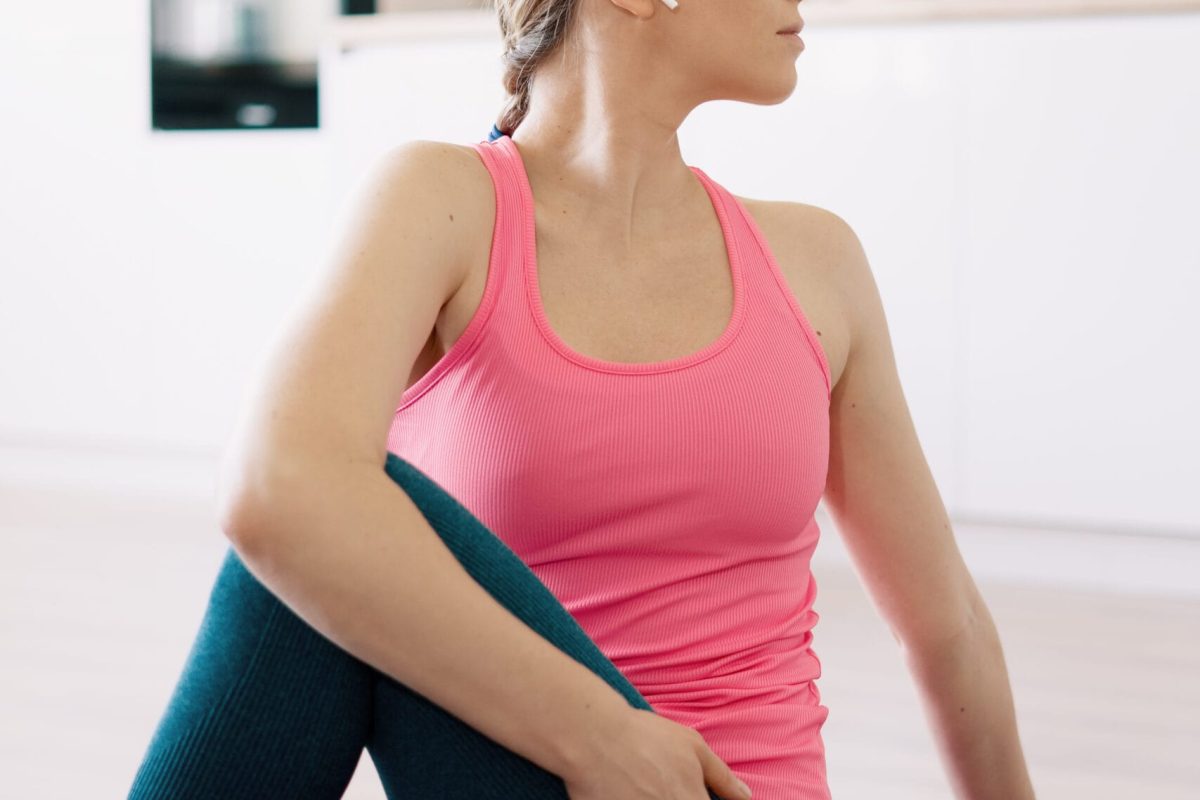 Attractive woman practicing yoga at home using online training instructions
